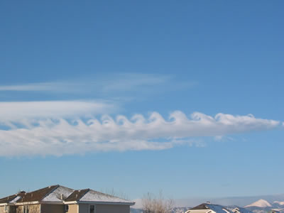 <a href="/earth/Atmosphere/clouds/kelvin_helmholtz.html&edu=elem">Kelvin-Helmholtz</a>
  clouds resemble breaking <a
  href="/earth/Water/ocean_waves.html&edu=elem">waves in
  the ocean</a>. They are usually the most developed near mountains or large
  hills. Wind deflected up and over a barrier, like a mountain, continues
  flowing through the air in a wavelike pattern. Complex <a
  href="/earth/Water/evaporation.html&edu=elem">evaporation</a>
  and <a href="/earth/Water/condensation.html&edu=elem">condensation</a>
  patterns create the capped tops and cloudless troughs of the waves. This
  image was taken on February 9, 2003 in the morning in Boulder, Colorado.<p><small><em>       Courtesy of Roberta Johnson</em></small></p>