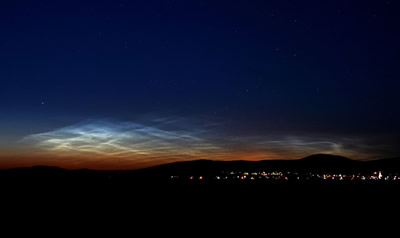 <a href="/earth/Atmosphere/NLC.html&edu=elem">Noctilucent</a>
  clouds are the highest clouds in the sky, but they are not associated with
  weather like the <a
  href="/earth/Atmosphere/clouds/cloud_types.html&edu=elem">other
  clouds</a> we regularly see in the sky. Noctilucent clouds form very high in
  the <a href="/earth/Atmosphere/overview.html&edu=elem">atmosphere</a>,
  in the <a
  href="/earth/Atmosphere/mesosphere.html&edu=elem">mesosphere</a>.
  They are best seen from Earth at sunset. This image was taken on June 15,
  2007, in Budapest, Hungary. Normally seen from locations near the <a
  href="/earth/polar/polar.html&edu=elem">poles</a> of
  the Earth, in recent years they have also been seen at much lower-latitude
  locations.<p><small><em> Image Courtesy of NASA/Veres Viktor</em></small></p>
