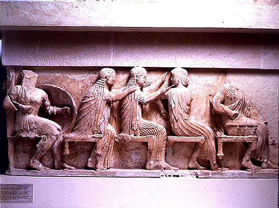 Left 
section of the east frieze of the Siphnian Treasury (c. 525 B.C.) depicting 
from left to right <a 
href="/mythology/Definitions_gods/Venus_def.html&dev=">
Venus</a>, <a 
href="/mythology/Diana_def.html&dev=">
Diana</a>, and <a 
href="/mythology/Definitions_gods/Apollo_def.html&dev=">
Apollo</a>. This portion of the frieze shows the gods sitting, watching the 
Greeks raid Troy.<p><small><em>   Image courtesy of the Superintendency (Ephoria) of Prehistoric and Classical Antiquities in Delphi. Greek Ministry of Culture-Archaeological Receipt Fund. (c) Greek Ministry of Culture.</em></small></p>